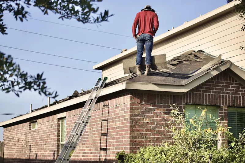 Professional roofer working on a residential roof in Newport Ridge